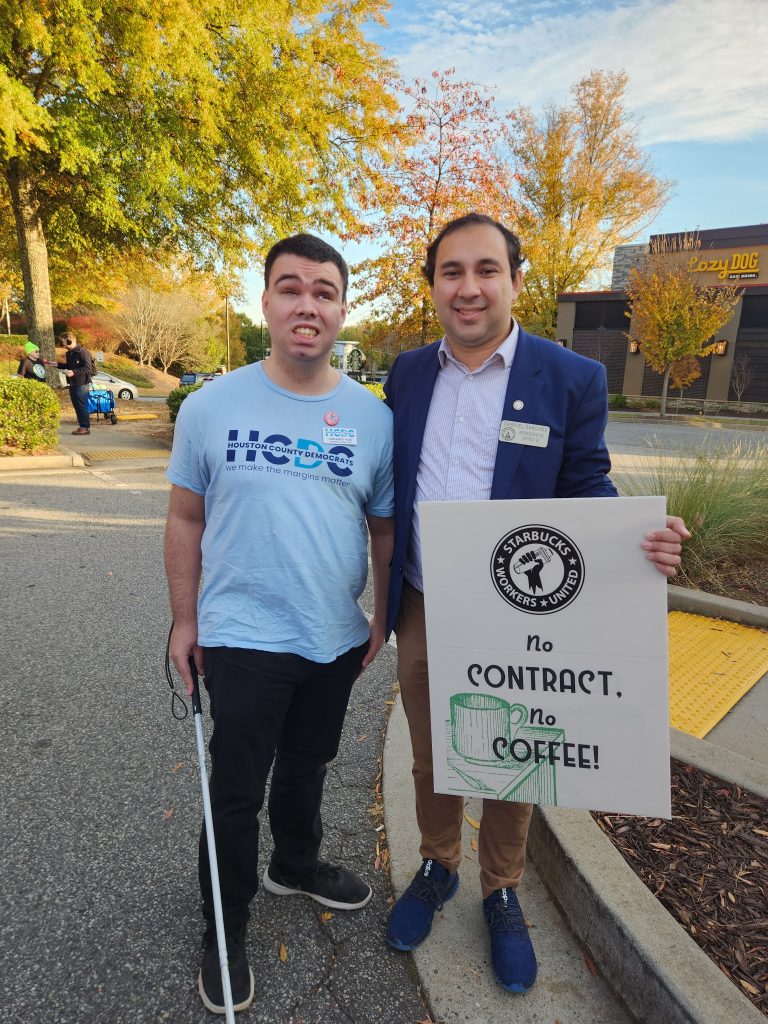 I'm standing with Rep. Gabriel Sanchez. He's holding a "No contract, no coffee!" sign in the Starbucks parking lot in Alpharetta, Georgia